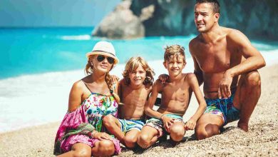 Happy family of four on beach