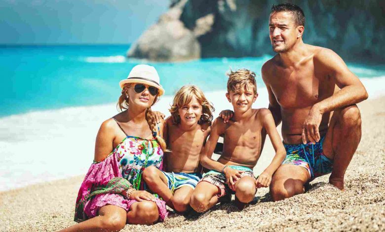 Happy family of four on beach