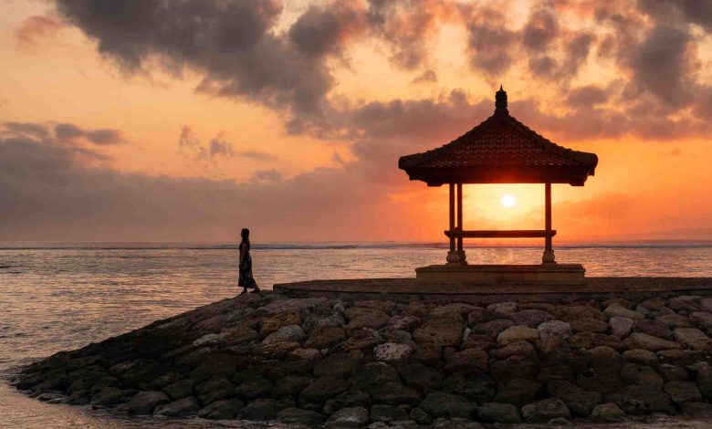 Woman with sunshine in pavilion on jetty at coastl