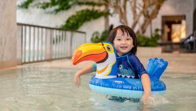Portrait of little boy in swimming pool on funny i