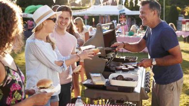 Man serving on barbeque stall at summer garden fet