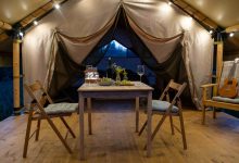 Romantic dinner setup inside of a tent