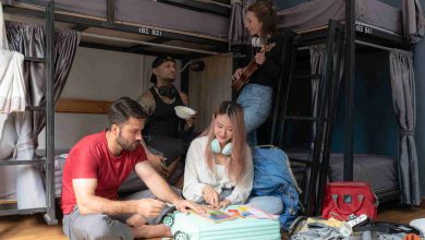 Four friends gathering in hostel bunkroom
