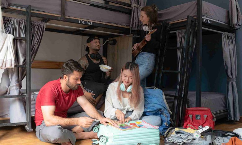 Four friends gathering in hostel bunkroom