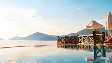 Infinity swimming pool with sea view against blue