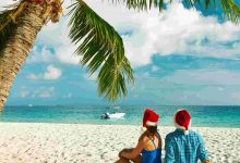 Couple in blue clothes on a tropical beach at chri