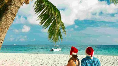 Couple in blue clothes on a tropical beach at chri