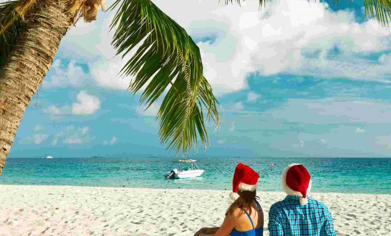 Couple in blue clothes on a tropical beach at chri