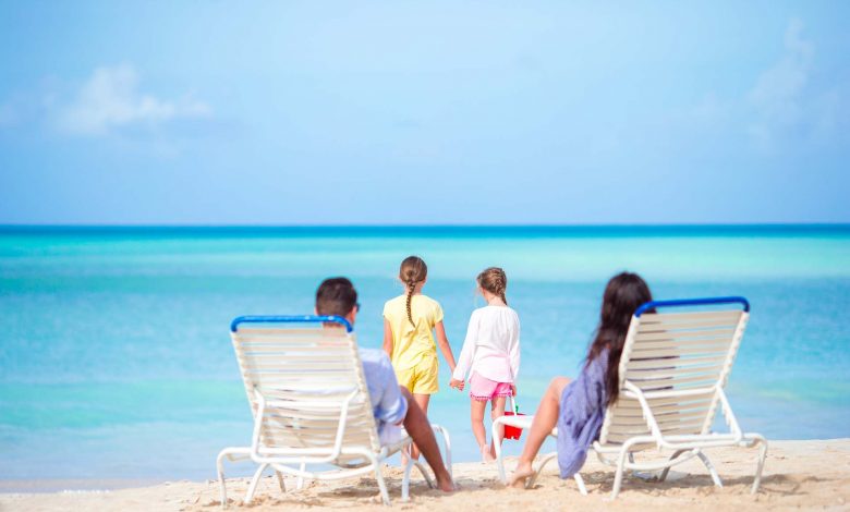 Happy beautiful family on a tropical beach vacatio