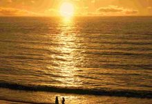 Couple meets at sunset beach