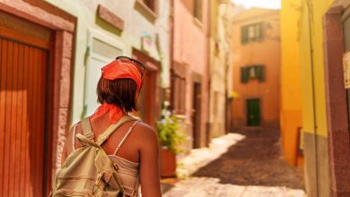 Woman walks along picturesque street in european t