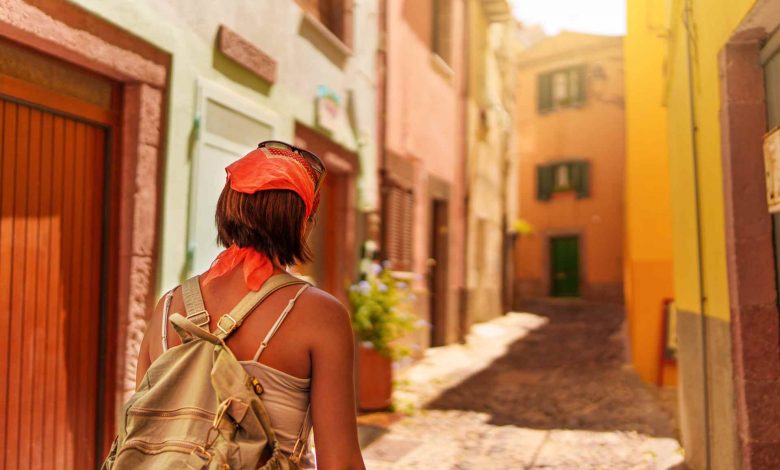 Woman walks along picturesque street in european t