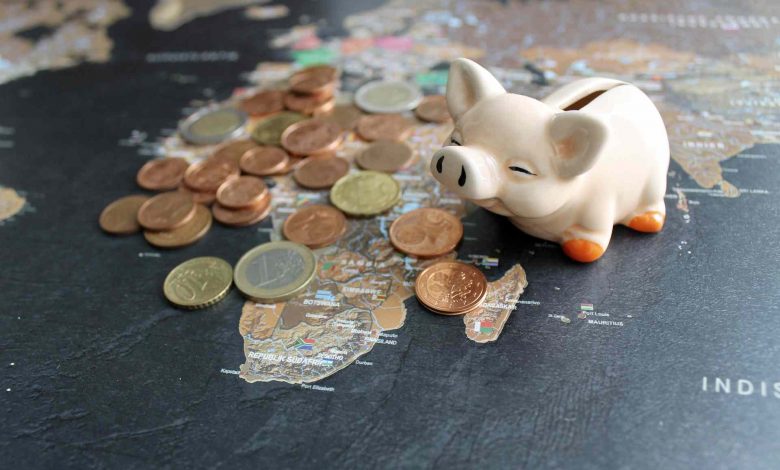 World savings piggy bank on world map