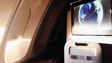 Airplane breakfast with earth displayed on screen