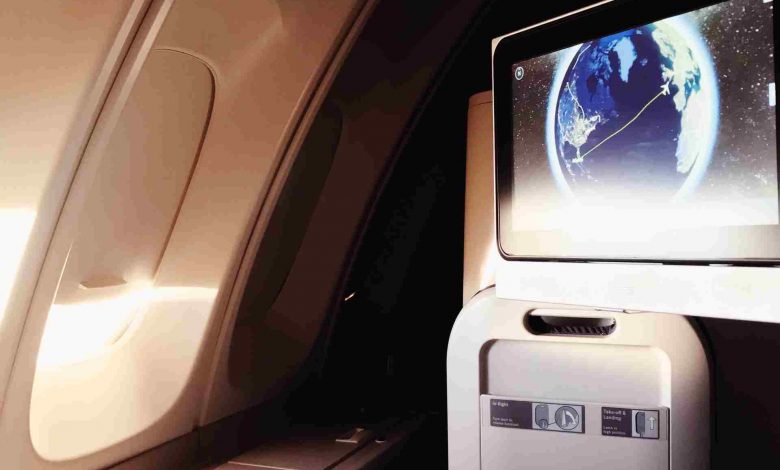 Airplane breakfast with earth displayed on screen