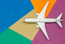 White airplane on colorful geometric background