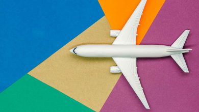 White airplane on colorful geometric background