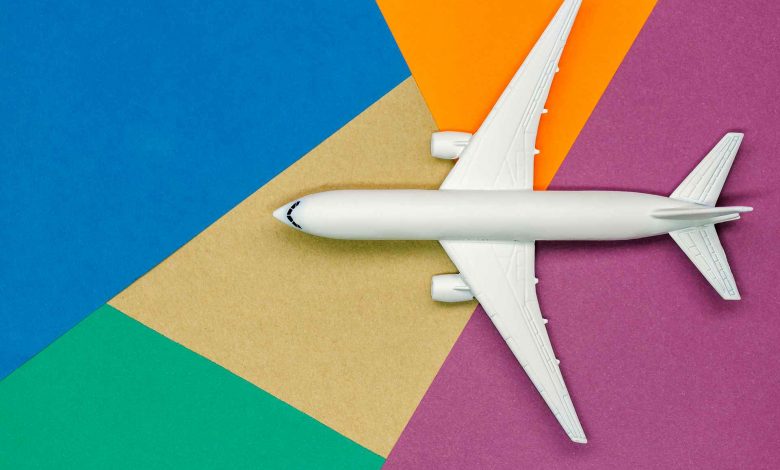 White airplane on colorful geometric background