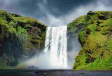 Majestic skogafoss waterfall flowing with rainbow