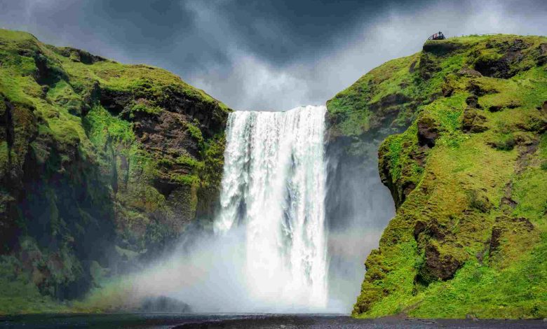 Majestic skogafoss waterfall flowing with rainbow