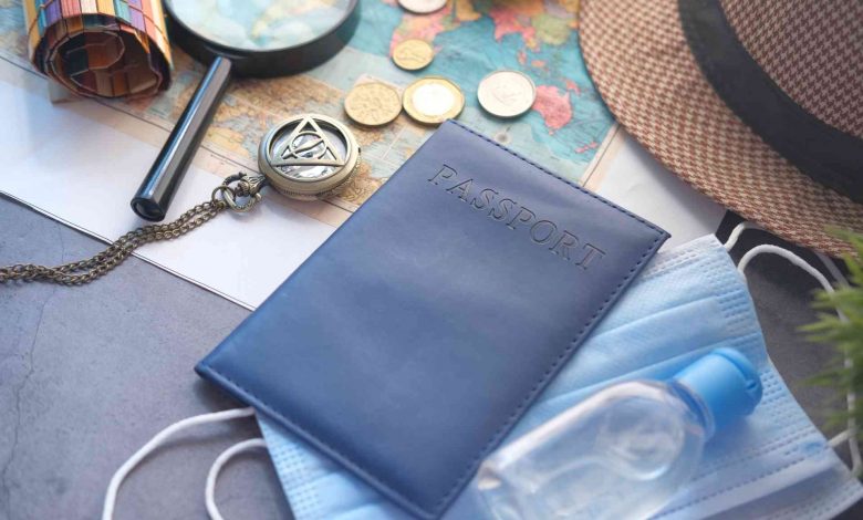 Travel planning still life with mask and passport