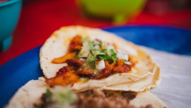 Close up view of a street taco of ground beef in s