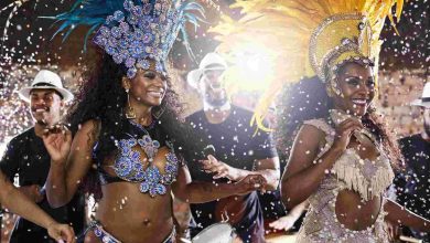 Carnival performers dancing with drummers in city