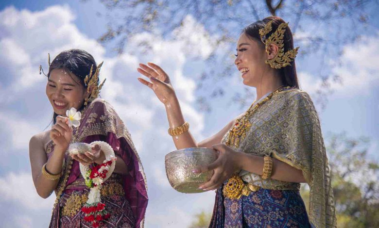 Women in traditional dress celebrate splashing wat