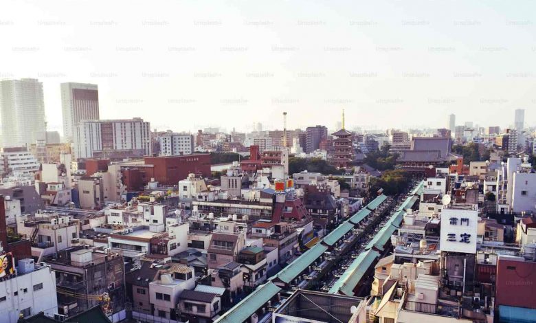 A train traveling through a city next to tall buil