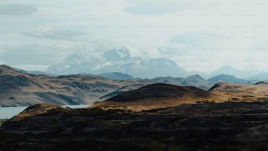 A view of a mountain range with a lake in the fore