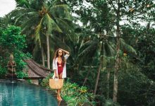 Woman in sunglasses red swimsuit and white shirt r