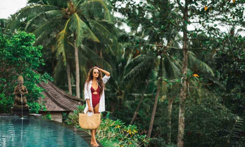 Woman in sunglasses red swimsuit and white shirt r