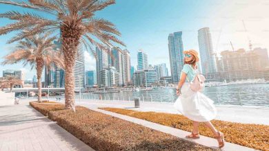 Happy asian girl walking on a promenade in dubai m